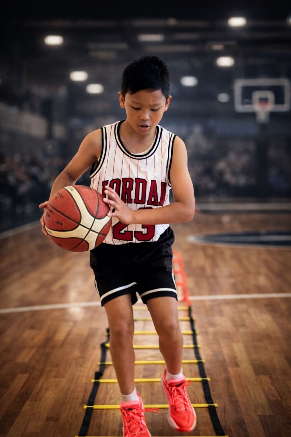 Young athlete holding a basketball during training session